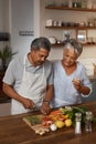 Marriage, old man and woman with wine, cooking in kitchen and healthy food, bonding together in home. Drink, glass and Royalty Free Stock Photo