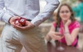 Marriage proposal concept. Man holds wedding ring behind back Royalty Free Stock Photo