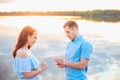 Marriage proposal on sunset . young man makes a proposal of betrothal to his girlfriend on the beach Royalty Free Stock Photo
