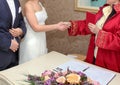 Marriage registrar congratulates new couple and gives the family registry to the bride