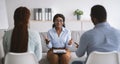 Marriage therapy concept. Black female psychologist having session with young married couple at clinic Royalty Free Stock Photo