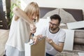 The marriage turns furniture for self-assembly. The woman is screwing the screw fastening the drawer rail with a screwdriver. Husb