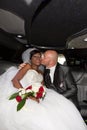 married bi-racial american couple in limousine wedding car Royalty Free Stock Photo