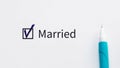 Married - checkbox with a tick on white paper with blue pen. Checklist concept.