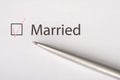 Married - checkbox with a tick on white paper with metal pen. Checklist concept