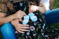 A married couple is close-up, the husband is hugging his pregnant wife for the stomach. Family is waiting for the birth Royalty Free Stock Photo