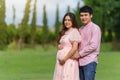 Married couple is expecting a baby. man embraces his pregnant wife in park Royalty Free Stock Photo