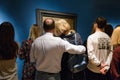 Married couple in front of the picture on theing day in the art gallery