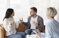 Married Couple Having Quarrel Sitting During Psychologist`s Appointment In Office Royalty Free Stock Photo