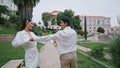 Married couple running garden alley. Excited cheerful man woman laughing in park Royalty Free Stock Photo