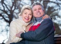 Married couple sitting on park bench