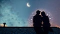 A married couple is sitting on the roof of a house at night. valentines day