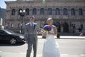 Married couple stand in middle of street in downtown Boston