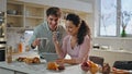 Married couple surfing internet having breakfast kitchen closeup. Family morning Royalty Free Stock Photo