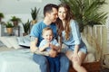 Married couple and their little baby baby in her arms. Young family at home in the morning on a day off. Joyful and happy faces Royalty Free Stock Photo