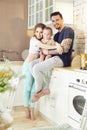 Married couple and their little baby baby in her arms. Young family at home in the morning on a day off. Joyful and happy faces Royalty Free Stock Photo