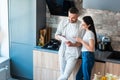 married couple using digital tablet together in kitchen smart