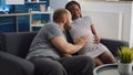 Married interracial couple bonding over child sitting at home Royalty Free Stock Photo