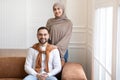 Married Middle-Eastern Couple Posing Together Smiling To Camera At Home