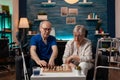 Married old couple playing chess game on board at home Royalty Free Stock Photo