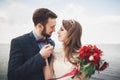 Married wedding couple standing on a wharf over the sea Royalty Free Stock Photo