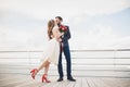 Married wedding couple standing on a wharf over the sea Royalty Free Stock Photo