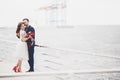 Married wedding couple standing on a wharf over the sea Royalty Free Stock Photo