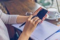 Close up of married woman hand using cellphone , holding pen Royalty Free Stock Photo