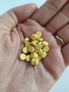 Married woman holds on hand a handful of yellow pills