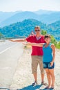 Married young couple hitchhiking