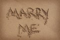 'Marry Me' Written in Sand on Beach Royalty Free Stock Photo