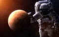 Mars on a blurred background with a giant astronaut. Elements of the image are furnished by NASA