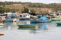 Marsaxlokk, Malta, August 2016. Numerous multi-colored fishing boats in the harbor of the city.