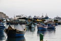 Marsaxlokk, Malta, August 2016. View of large and small fishing boats in the harbor.