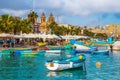 Marsaxlokk, Malta - Traditional colorful maltese Luzzu fisherboat at the old village of Marsaxlokk with turquoise sea water
