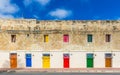 Marsaxlokk, Malta - Traditional maltese vintage house with orange, blue, yellow, red, green and brown doors and windows Royalty Free Stock Photo