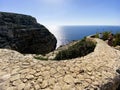 Marsaxlokk, Malta - 10-24-22 - Winding stone wall and walking path along the ocean