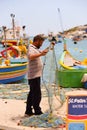 Traditional eyed colorful boats Luzzu in the Harbor of Mediterranean fishing village Marsaxlokk, Malta Royalty Free Stock Photo