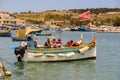 Traditional eyed colorful boats Luzzu in the Harbor of Mediterranean fishing village Marsaxlokk, Malta Royalty Free Stock Photo