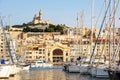 `La Criee` theater hall on the wharf of the Old Port and Notre-Dame de la Garde basilica at sunset in Marseille, France. Royalty Free Stock Photo