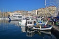 Marseille old town main harbour front with busy crowded fish market, fish monger selling fish nearby their fishing boats Royalty Free Stock Photo