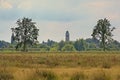 Marshland with meadows and trees uand church in the distance Royalty Free Stock Photo