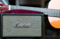 Marshall speaker closeup with acoustic guitar background