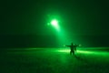 marshaller signal to helicopter for night landing from night vision goggles view Royalty Free Stock Photo