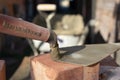 Marshalltown trowel in mortar cement and bricks for brickwork, part of a renovation of an Edwardian house in north London, UK