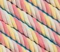 Marshmallow background. Sweet candy colorful diagonal texture. Rainbow colored marshmallow twists. Royalty Free Stock Photo