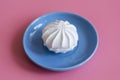 Marshmallow in a blue plate on a pink background Royalty Free Stock Photo