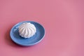 Marshmallow in a blue plate on a pink background. copy space Royalty Free Stock Photo