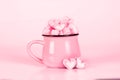 Marshmallow heart shape in cup on pink background with love conc Royalty Free Stock Photo