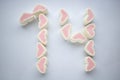 Marshmallow hearts aligned to be number fourteen for valentine`s day. on white background